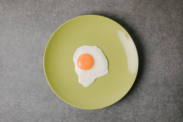istock top view of fresh tasty fried egg on plate on grey 949356338