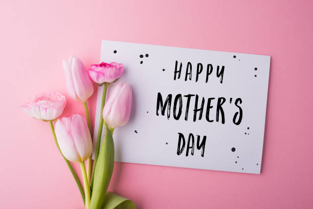 istock Mothers day composition. Note and flowers. Studio shot. 949356348