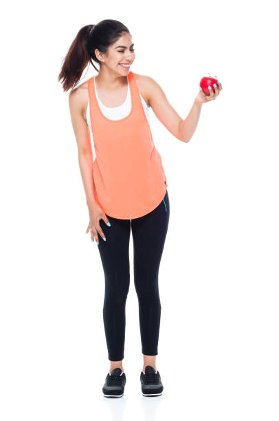 istock Woman in exercise clothes holding an apple 949360268