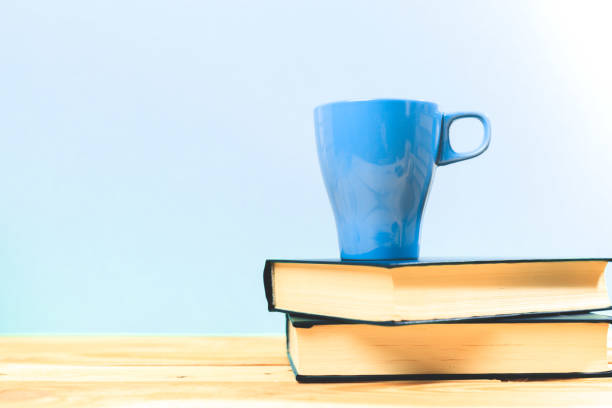 istock Color cup of tea with books on table 949364648
