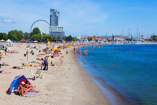 Gdynia, Poland - July 16, 2017:Crowded beach in beautiful summer day at Gdynia beach, Poland. Gdynia is a tourist resort in the Pomeranian Voivodeship of Poland