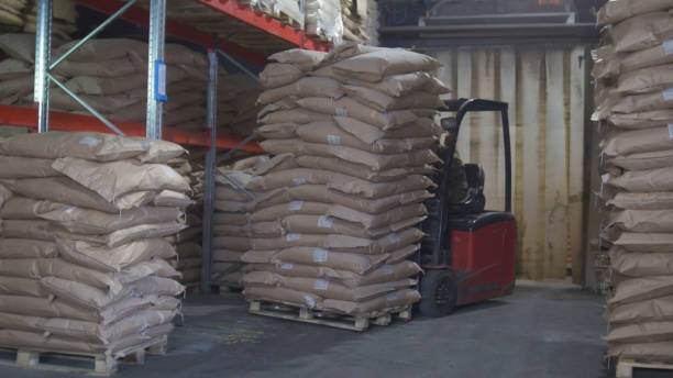 istock Loaders transport pallet with boxes on industrial warehouse 949369814