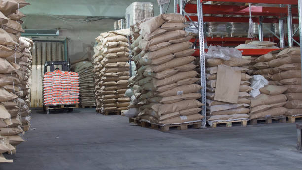 istock Red loaders transport pallet with boxes on industrial warehouse 949369830