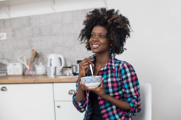 istock Young African woman eating breakfast 949370240