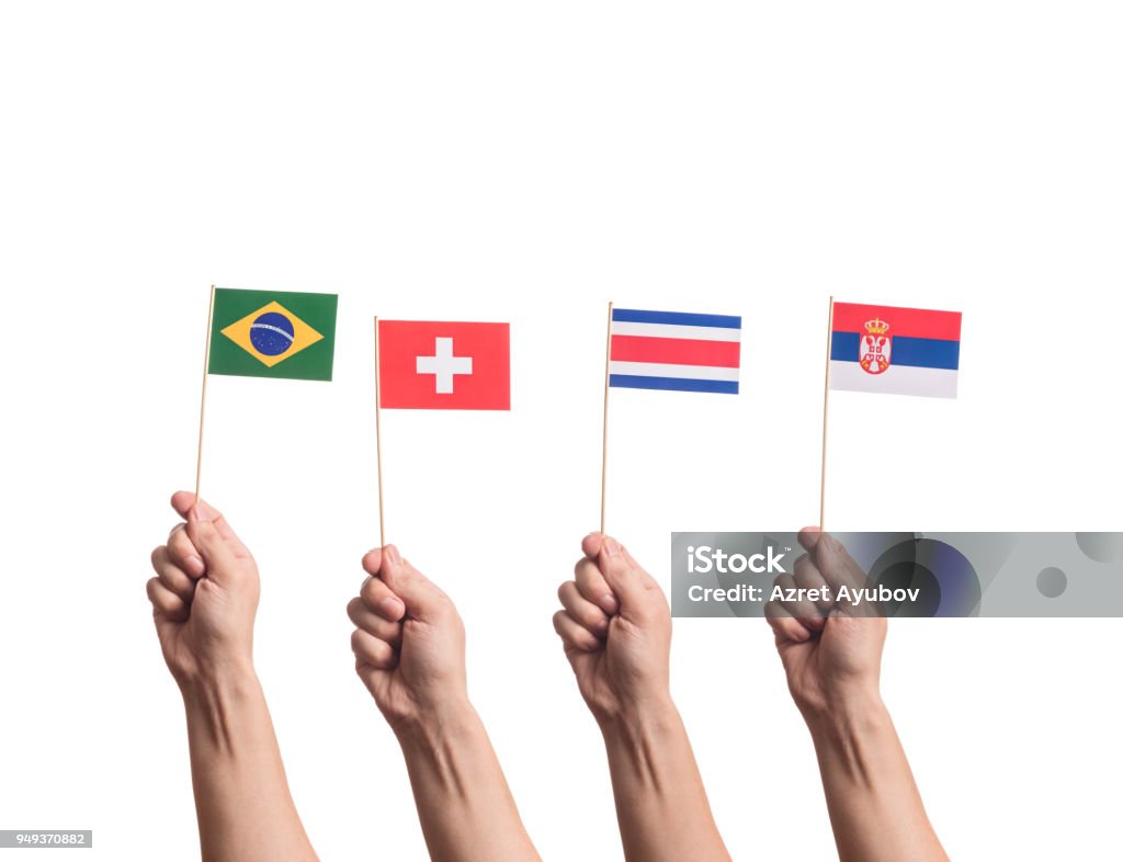 National flags in hands Little paper national flags in hands isolated on white background. Flags of Brasil, Switzerland, Costa Rica, Serbia. Flag Stock Photo