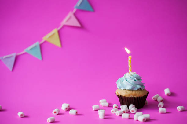 istock Birthday cupcake on pink background 949374912