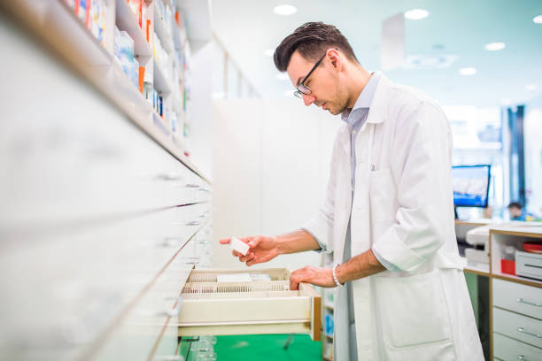 istock Portrait of a young friendly male pharmacist. 949376136