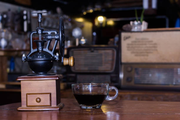 istock Coffee grinders and black coffee cups are on the table. 949383638