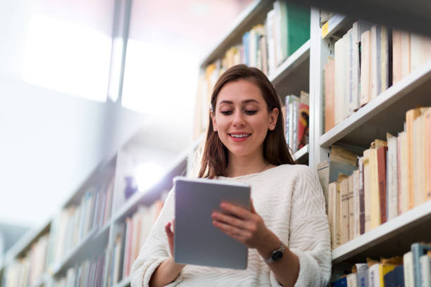 istock Young female student studying in the library 949386156