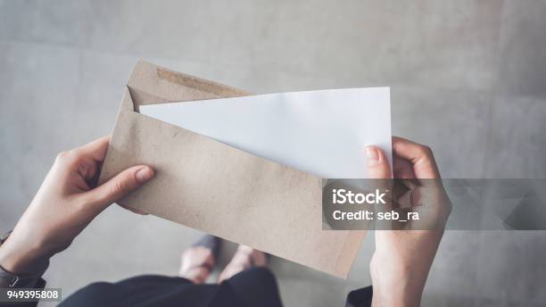 Stand Up Woman Holding White Folded A4 Paper And Brown Envelope Stock Photo - Download Image Now