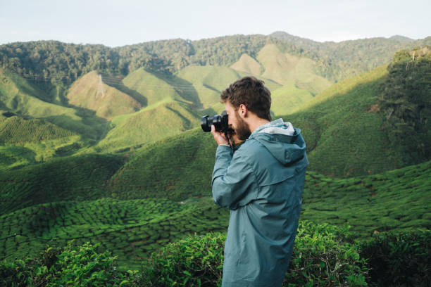 istock Man  taking photo  at tea plantations 949396246
