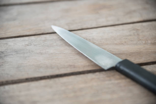 istock Close up Knife on wood table. 949400122