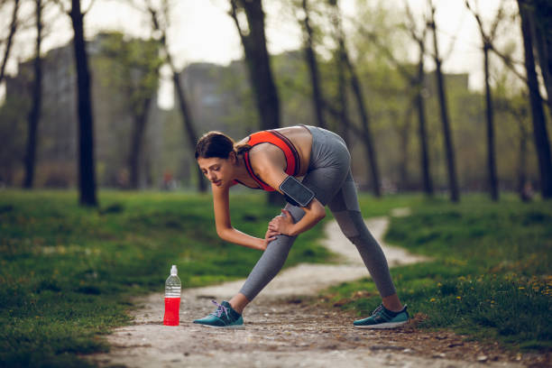 istock Beautiful sporty woman stretching, warming up before working out 949400130