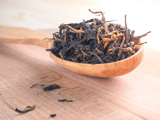 istock Loose tea in a wooden dish with a spoon. 949403742