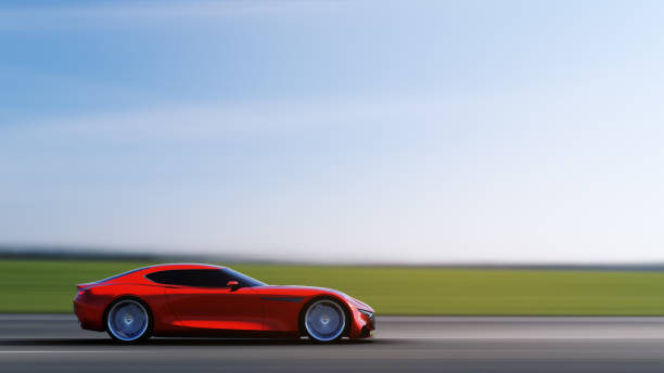 istock red car driving on a road 949404292