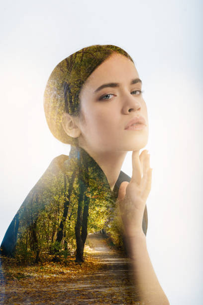 istock Young woman touching her face while using facial cream 949405608