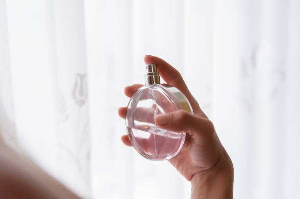 istock Elegant bride holding in hands a bottle of luxury perfume 949406132