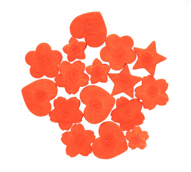 istock Carrot cut in heart, sakura and star shaped on white background. 949409344