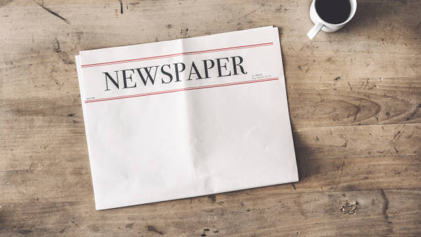 Newspaper and coffee on wooden background