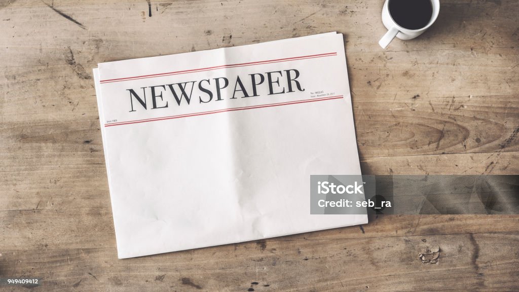 Newspaper and coffee on wooden background Newspaper Stock Photo