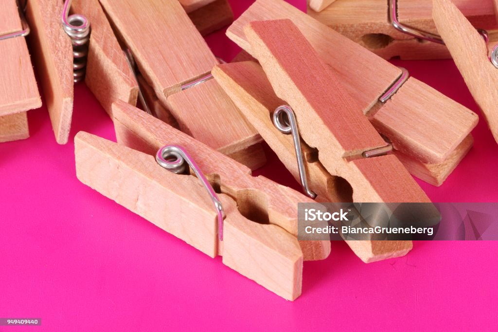 wooden clothespins a heap of wooden clothespins lying in the pink studio Clamp Stock Photo