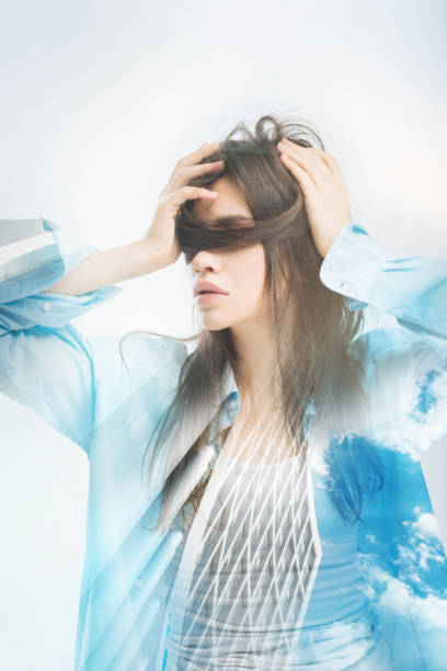 istock Creative woman touching her head while standing alone in her room 949412456