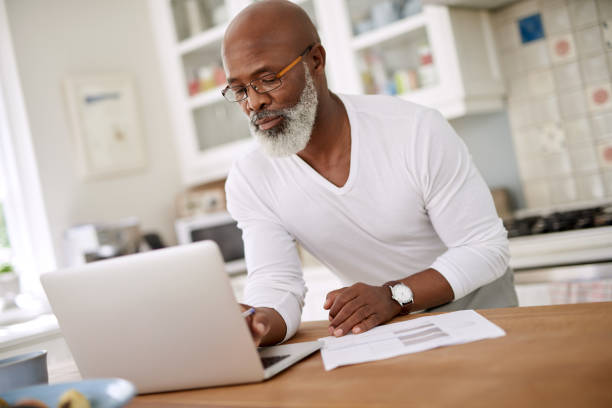 istock Keeping an organized log of all his finances 949413072