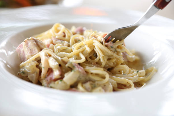 istock Spaghetti carbonara white sauce with bacon and cheese 949417486