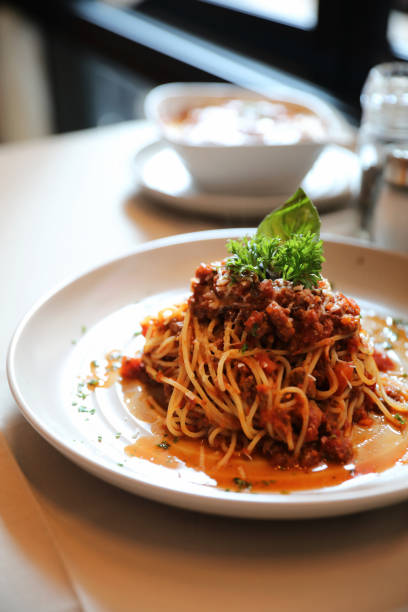 istock spaghetti Bolognese with minced beef and tomato sauce garnished with parmesan cheese and basil , Italian food 949417678
