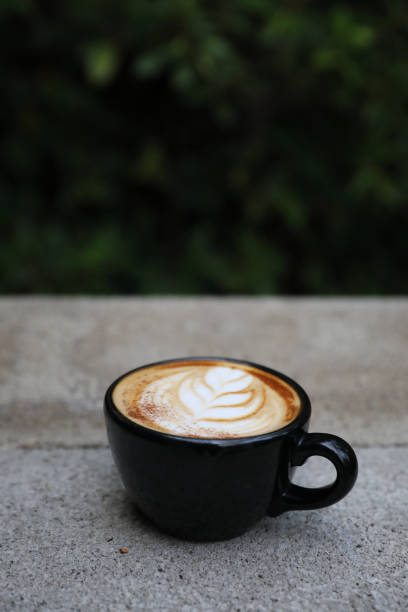 istock Cappuccino coffee cup on wood background 949418116
