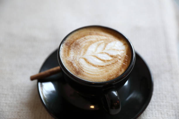 istock Cappuccino coffee cup on wood background 949418120