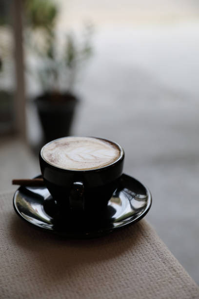 istock Cappuccino coffee cup on wood background 949418158