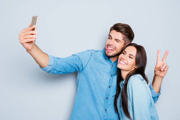 retrato de dos amantes felices haciendo selfie en smartphone - made man object fotografías e imágenes de stock