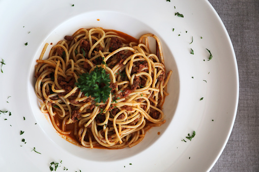 Spaghetti bolognese with beef tometo sauce on wood table , italian food