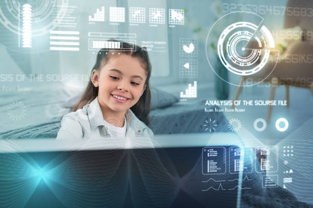 istock Smiling child looking at the big computer and smiling happily 949420890