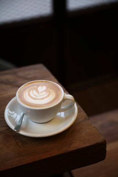 istock Cappuccino coffee cup on wood background 949420944