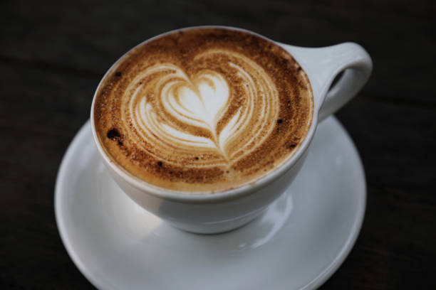 istock Cappuccino coffee cup on wood background 949420972
