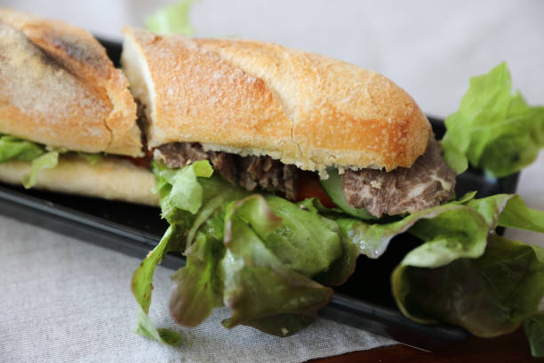 istock Beef sandwich on wood background 949421770