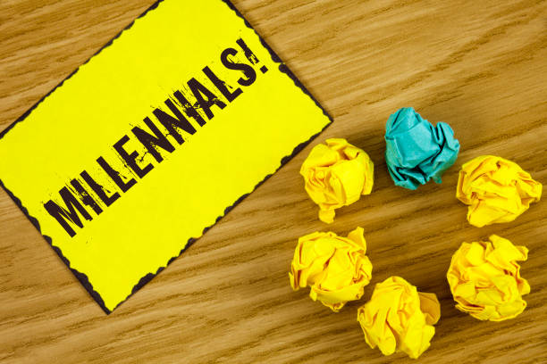 istock Handwriting text Millennials Motivational Call. Concept meaning Generation Y Born from 1980s to 2000s written on Sticky Note paper on wooden background Crumpled Paper Balls next to it. 949421782