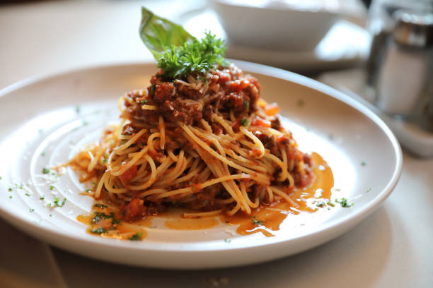 istock spaghetti Bolognese with minced beef and tomato sauce garnished with parmesan cheese and basil , Italian food 949425076