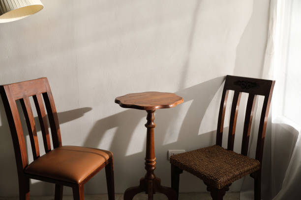 istock Wooden table and chairs with lamp on wall 949426034