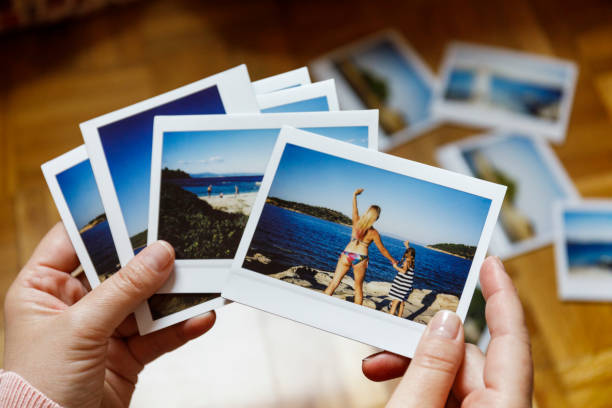istock Browsing vacation photographs at home - a closeup 949426340