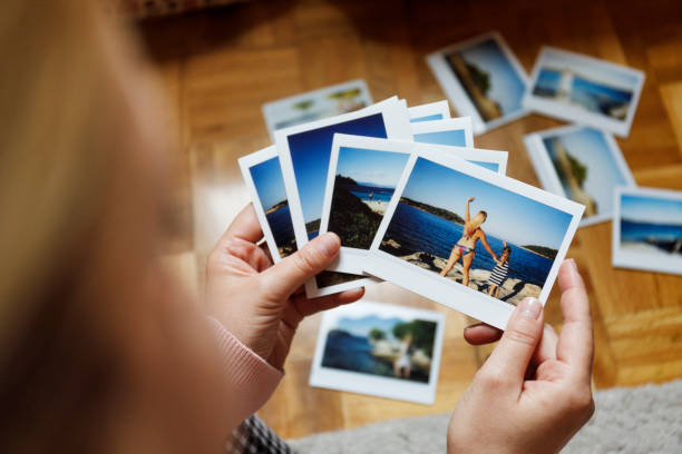istock Browsing vacation photographs at home 949426702