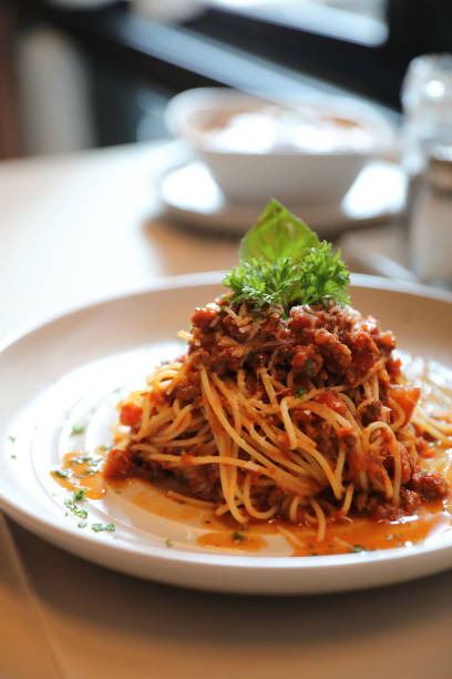 istock spaghetti Bolognese with minced beef and tomato sauce garnished with parmesan cheese and basil , Italian food 949427072