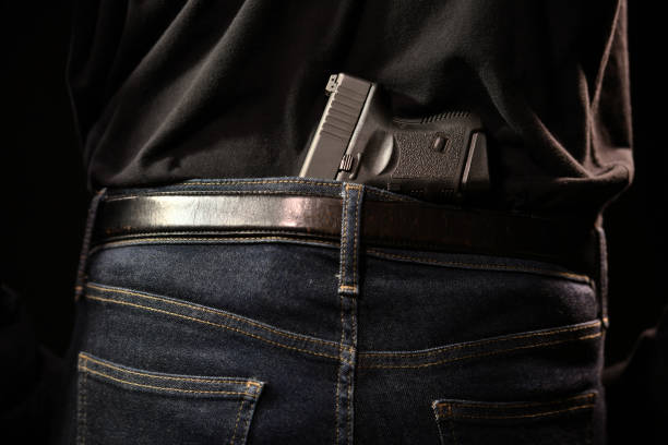 istock The man concealing gun behind his back 949430726
