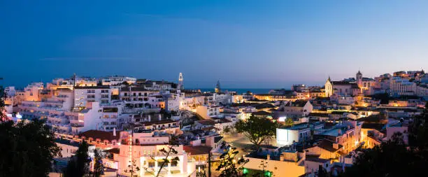 Panoramic, night view of the Old Town of Albufeira City in Algarve, Portugal. Albufeira is a coastal city in the southern Algarve region of Portugal. It"u2019s a former fishing village that has become a major holiday destination.
