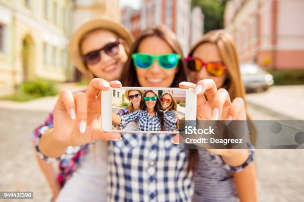 Three Happy Best Girlfriends In Glasses Making Selfie On Smartphone Stock Photo - Download Image Now