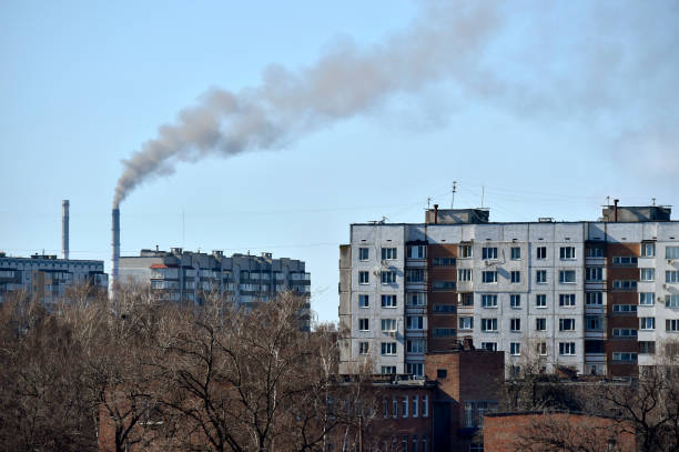 View of the city with industrial pipes of an electric power plant View of the city Cherkasy with industrial pipes of an electric power plant. Smoke from the pipe above the living houses. cherkasy stock pictures, royalty-free photos & images