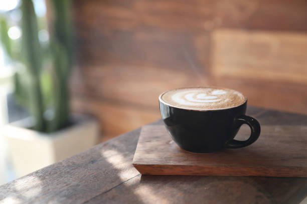 istock Cappuccino coffee break on wood background 949432662
