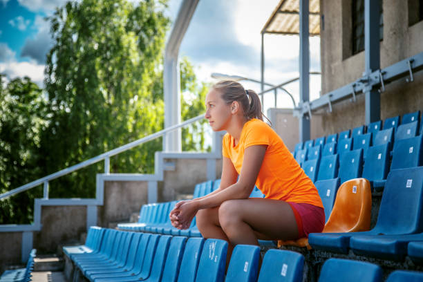istock Slim female in orange sportswear. 949432906